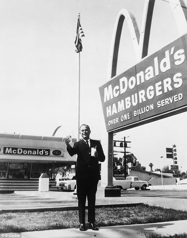 Rival: Ray Kroc outside one of his franchises holding a hamburger and a drink. He had offered a deal to the McDonald brothers to franchise their success but their relatives say he cheated them