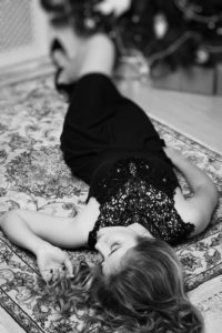 Beautiful young woman lying on the floor in boudoir